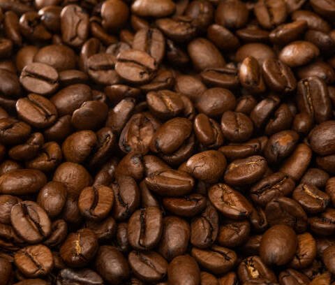 Dark roasted coffee beans arabica with rich oily texture.